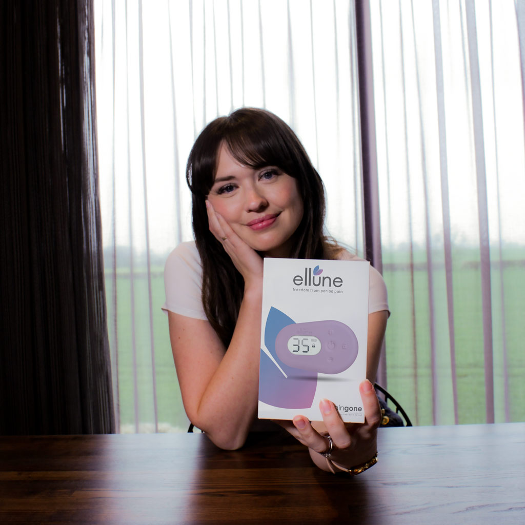 Woman holding image of Paingone Ellune towards the camera