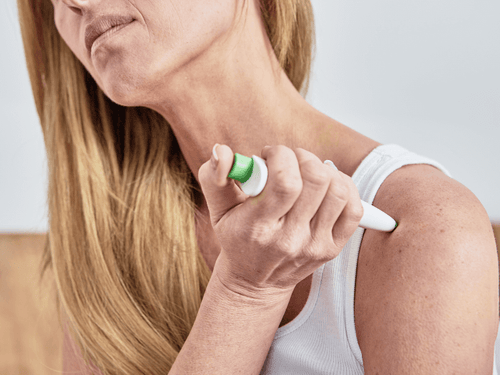 Woman applying paingone one to relieve a painful area